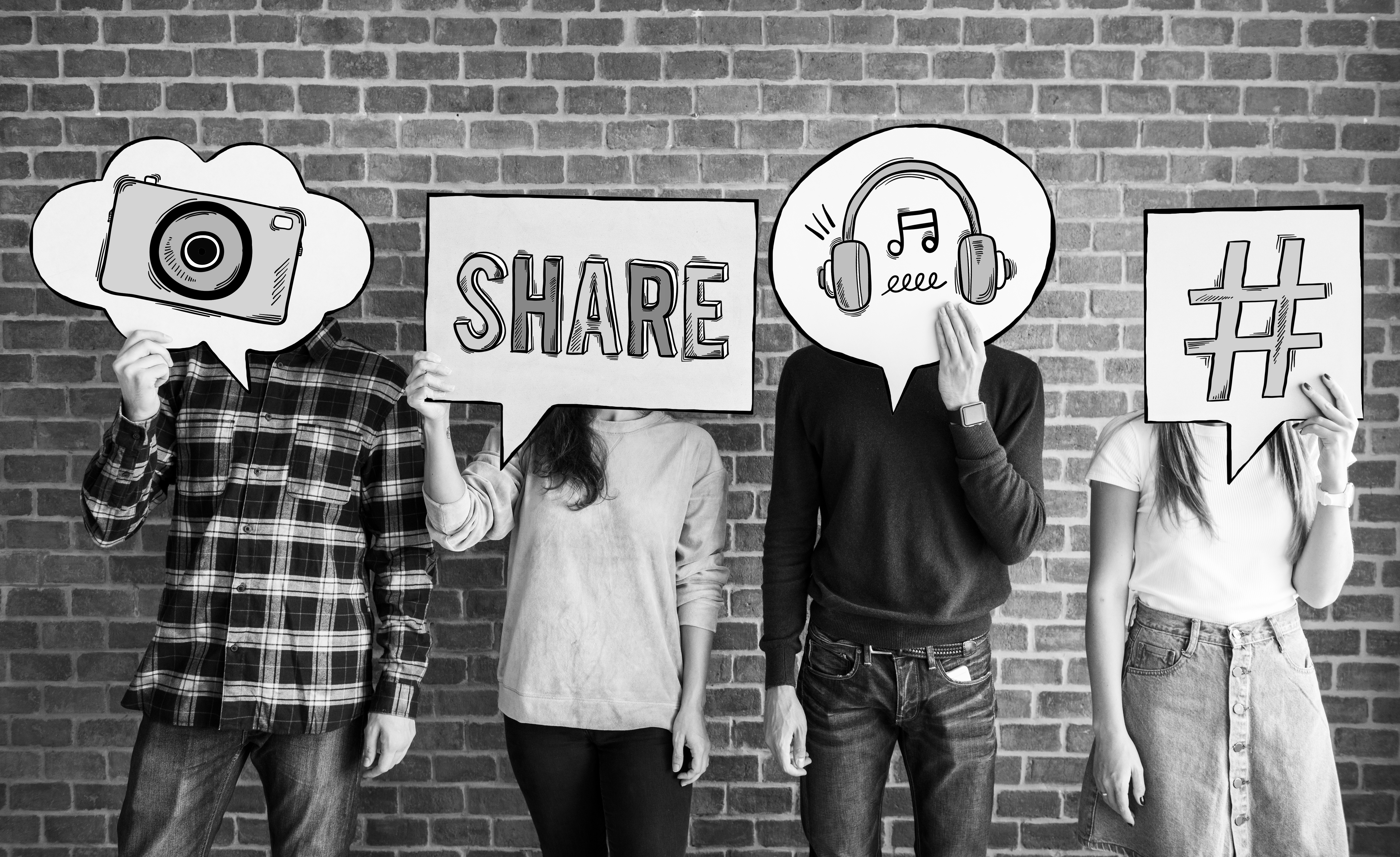 Friends holding up thought bubbles with social media concept icons Friends holding up thought bubbles with social media concept icons